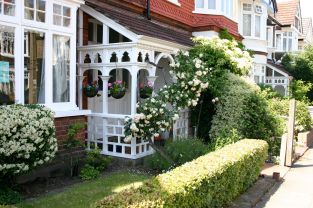 front porch with hanging baskets